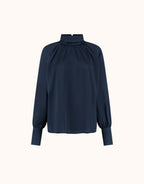Packshot of the Alix Midnight Blue satin blouse with a high gathered neck and cuffs.