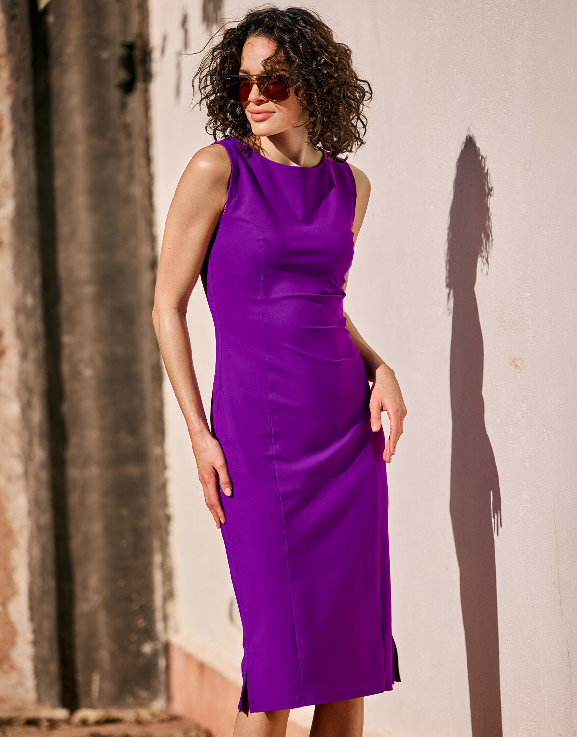 Model standing in the Gloria Violet dress in jersey lycra with sunglasses.