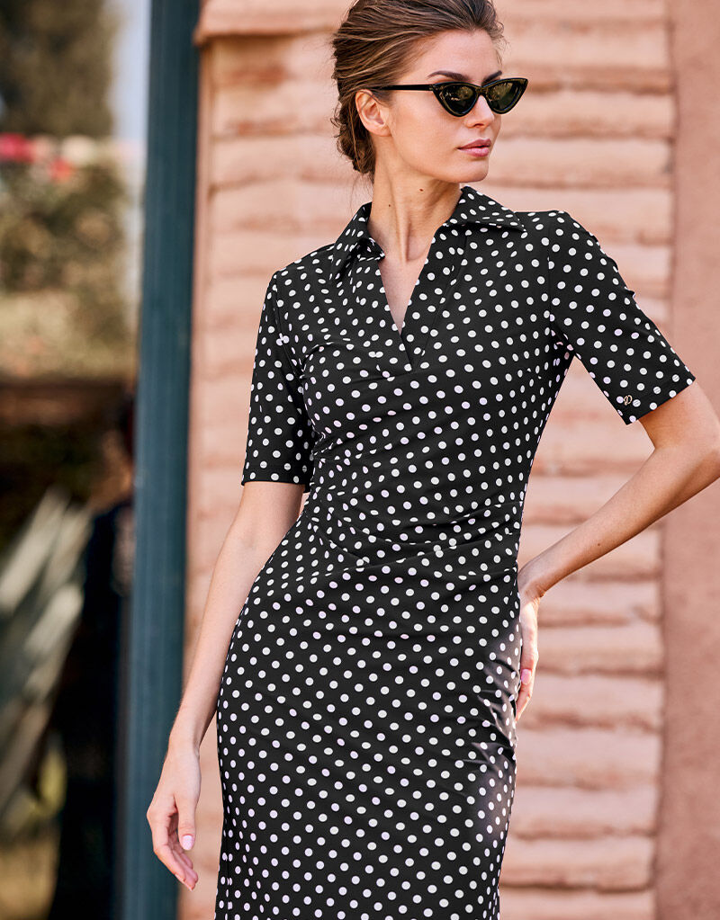 Model outdoors in the Arlette Ivory small dot maxi dress with a polo collar.