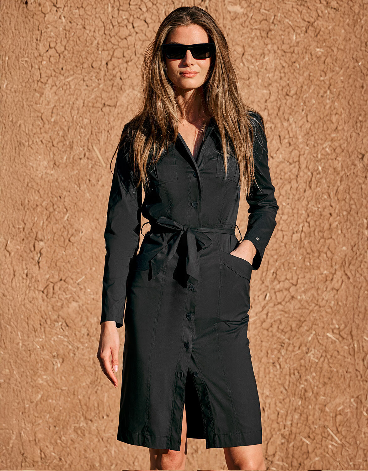 Model outdoors in the Ayla Black shirt dress in cotton poplin with a tied belt.