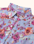 Blue shirt with floral print and gold accents, button closure, colorful design for a lively look