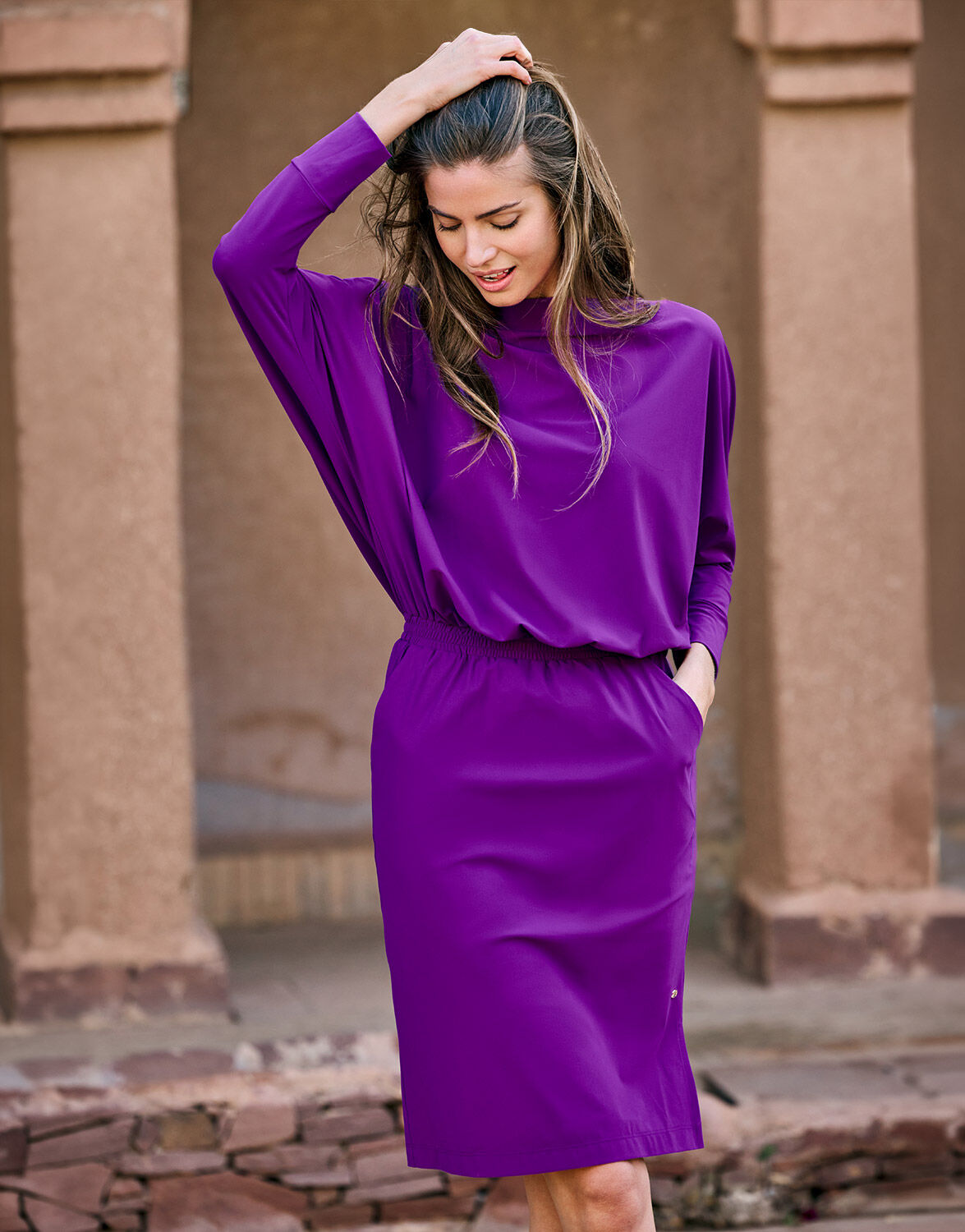 Model standing in the Lumi Violet dress in jersey lycra with an elasticated waist.