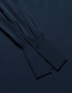 Detail of the Alix Midnight Blue satin blouse showing the buttoned cuff.