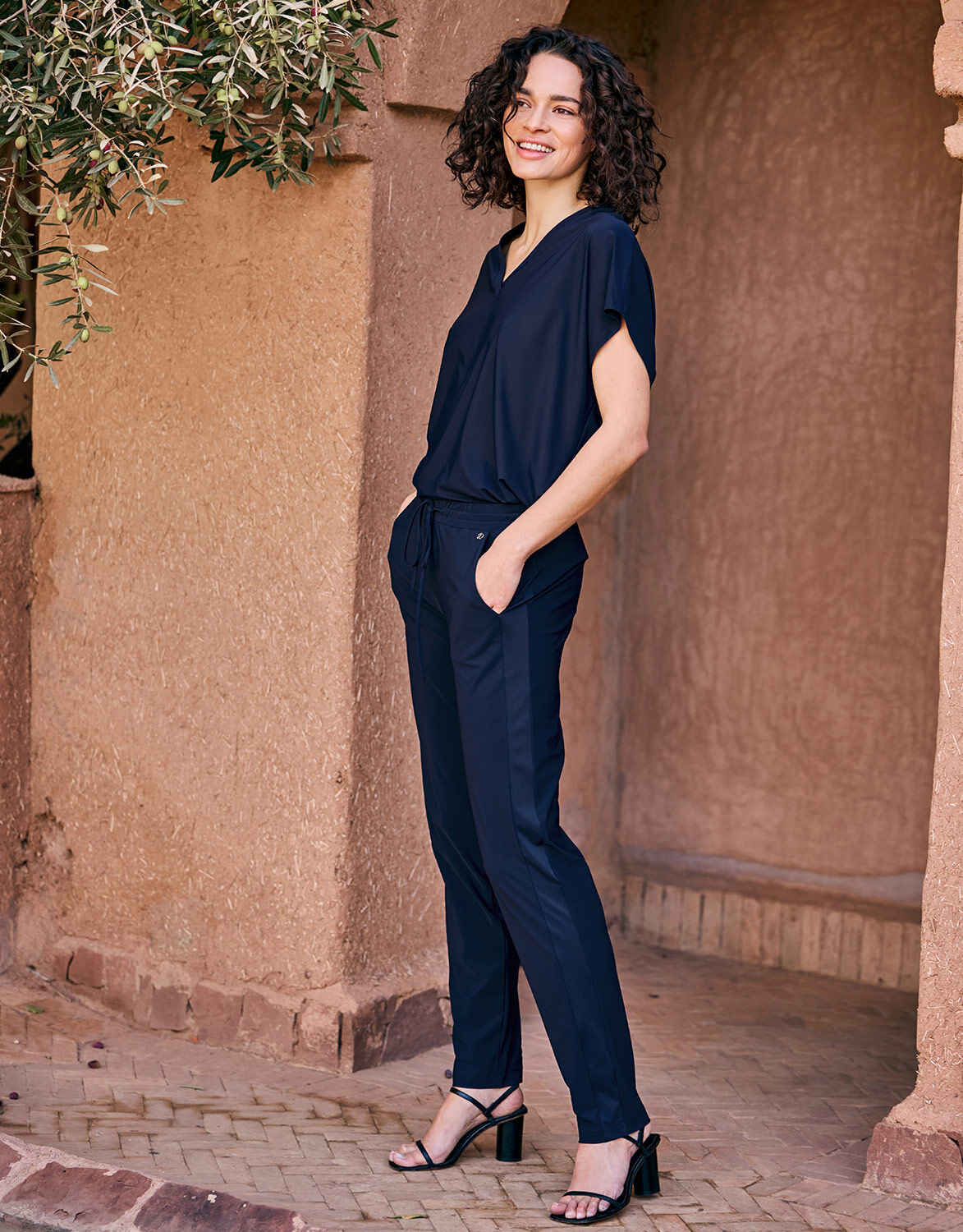 Model standing in the Valencia Midnight Blue trousers in jersey lycra with a matching top.