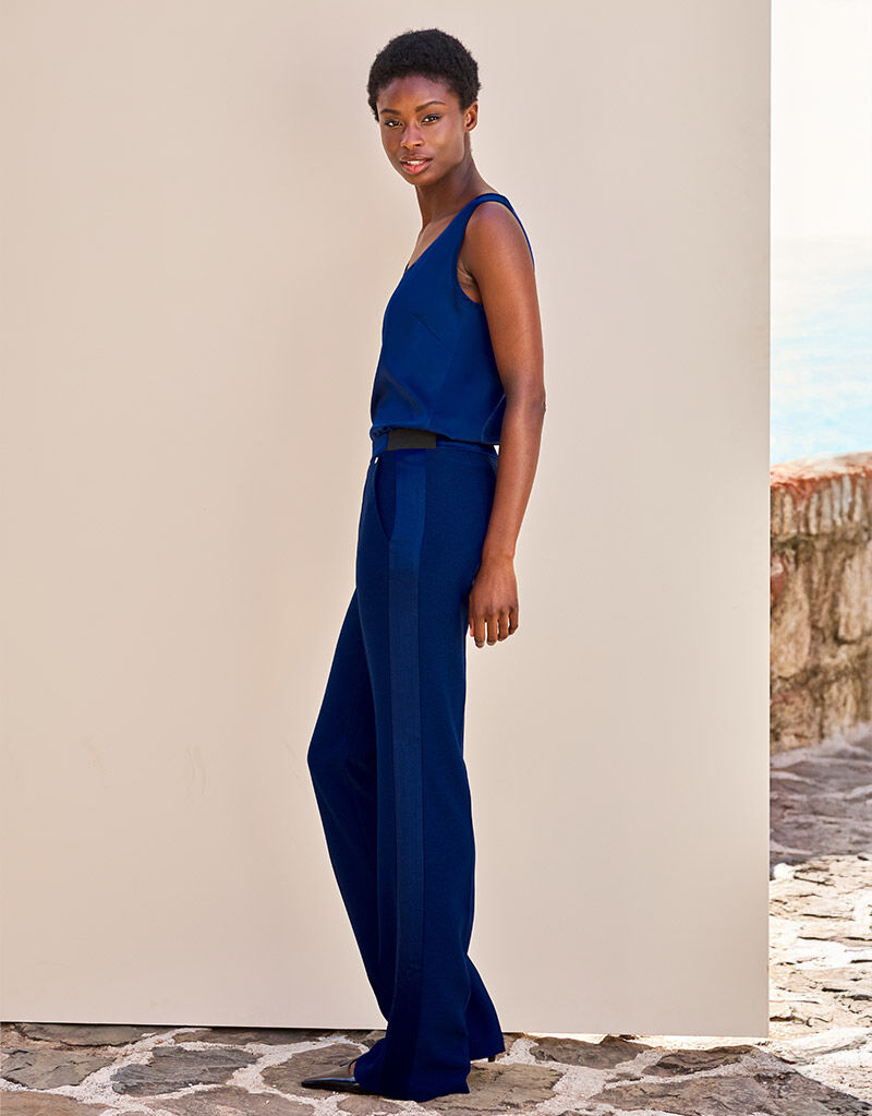 Model standing in the Palma Sapphire blue trousers in crepe satin with a matching top.
