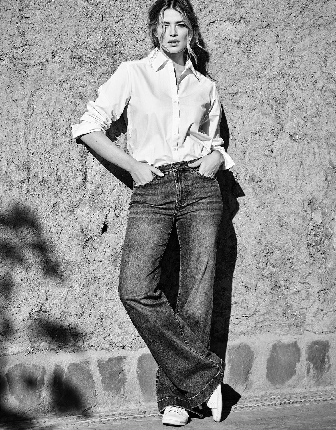 Model standing in the Manuela Washed Navy jeans in stretch cotton with a white blouse.