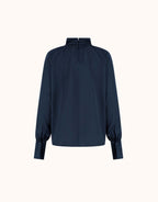 Packshot of the Alix Midnight Blue satin blouse with balloon sleeves and buttoned cuffs.