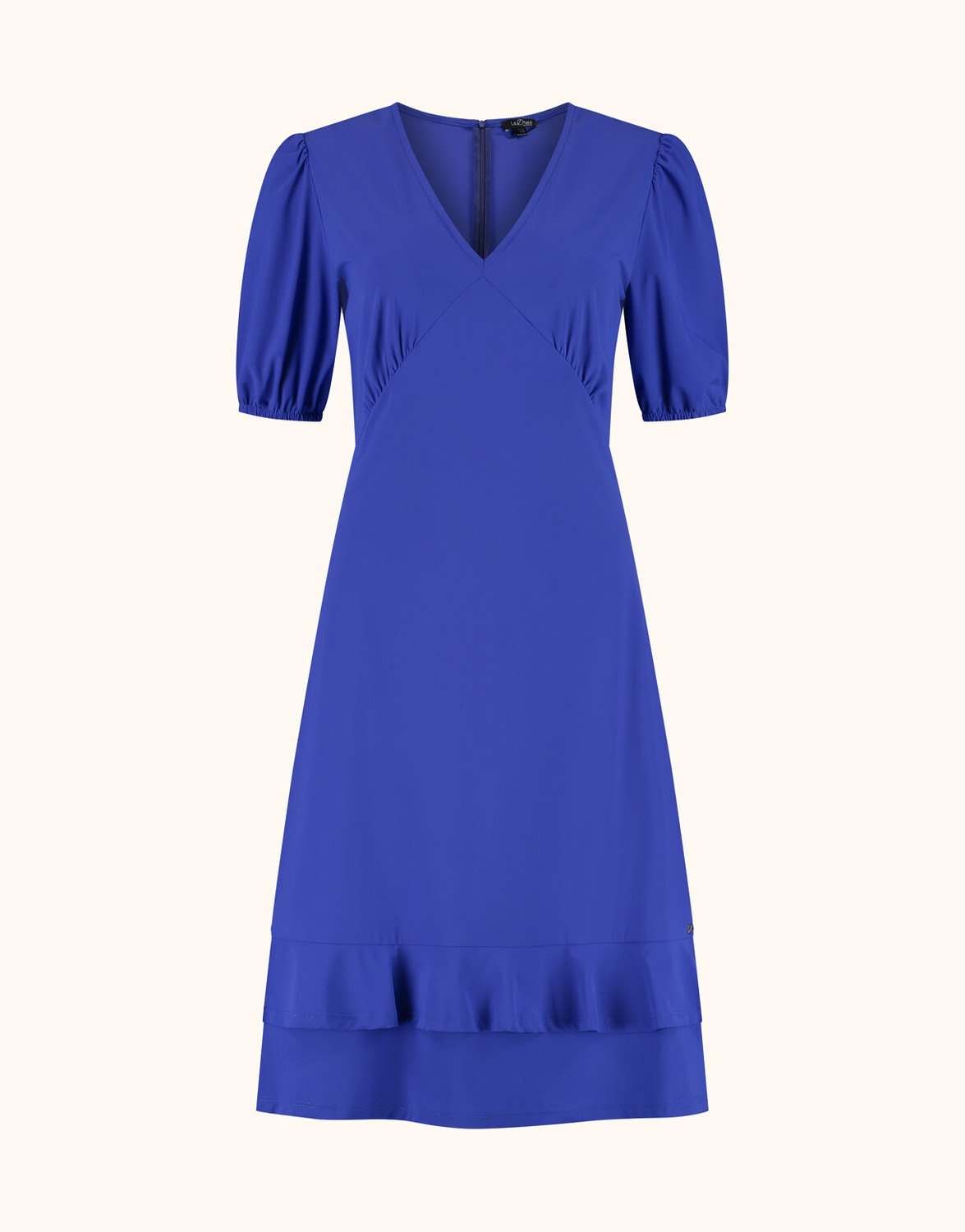 Packshot of the Kaya Marine Blue dress in jersey lycra with a V-neck and a ruffled hem.