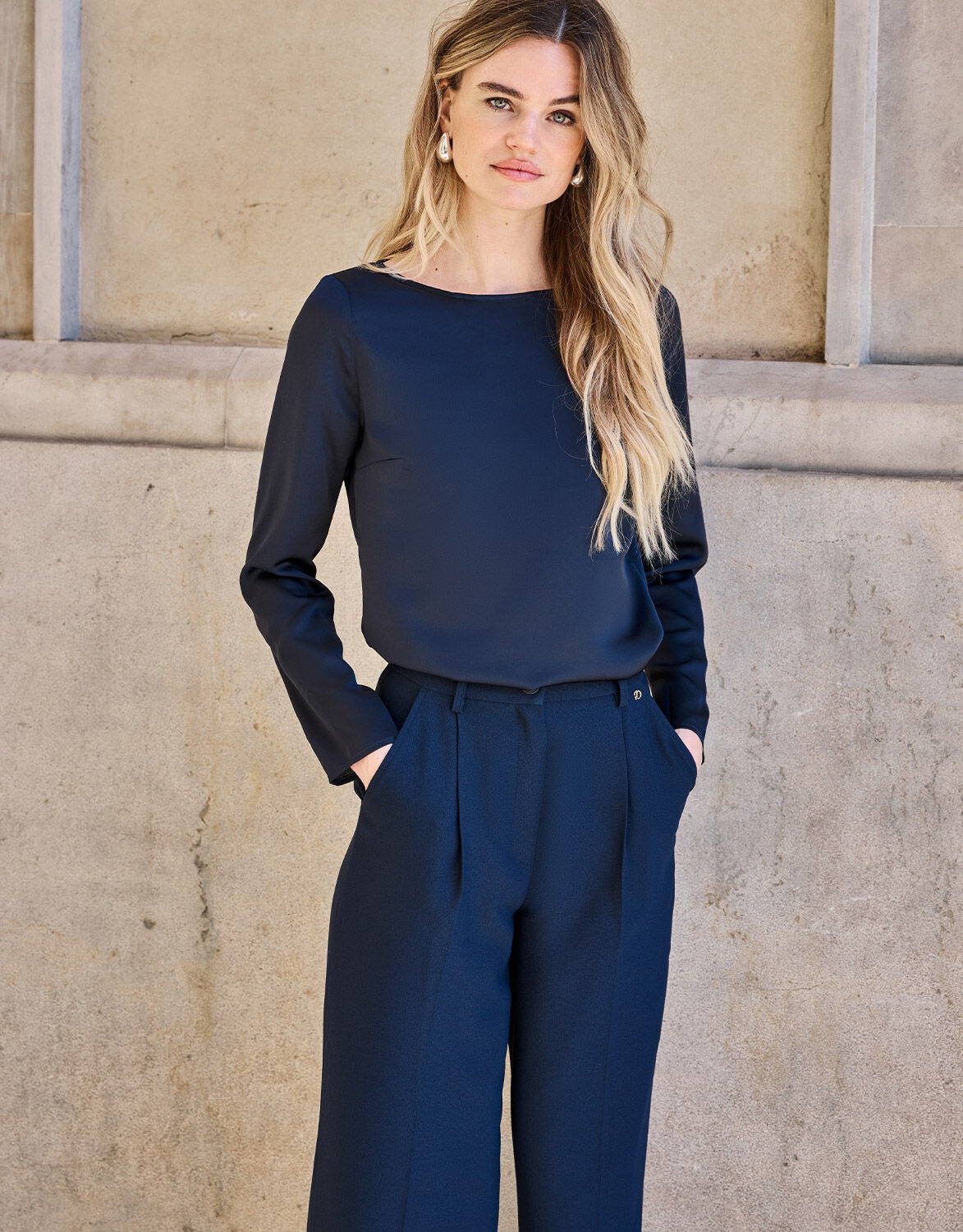 Model standing in the Dorian Midnight Blue top in satin with matching wide trousers.
