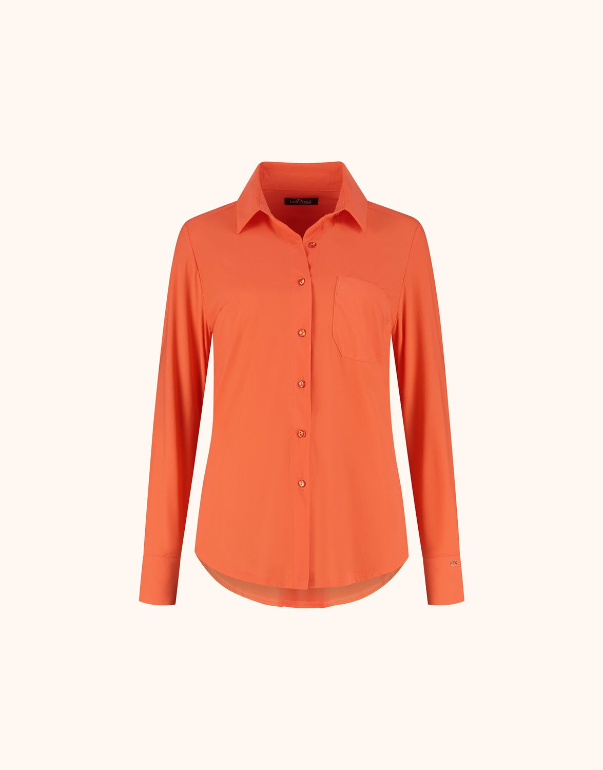 Packshot of the Annie Soft Orange shirt in jersey lycra with a collar and pocket.