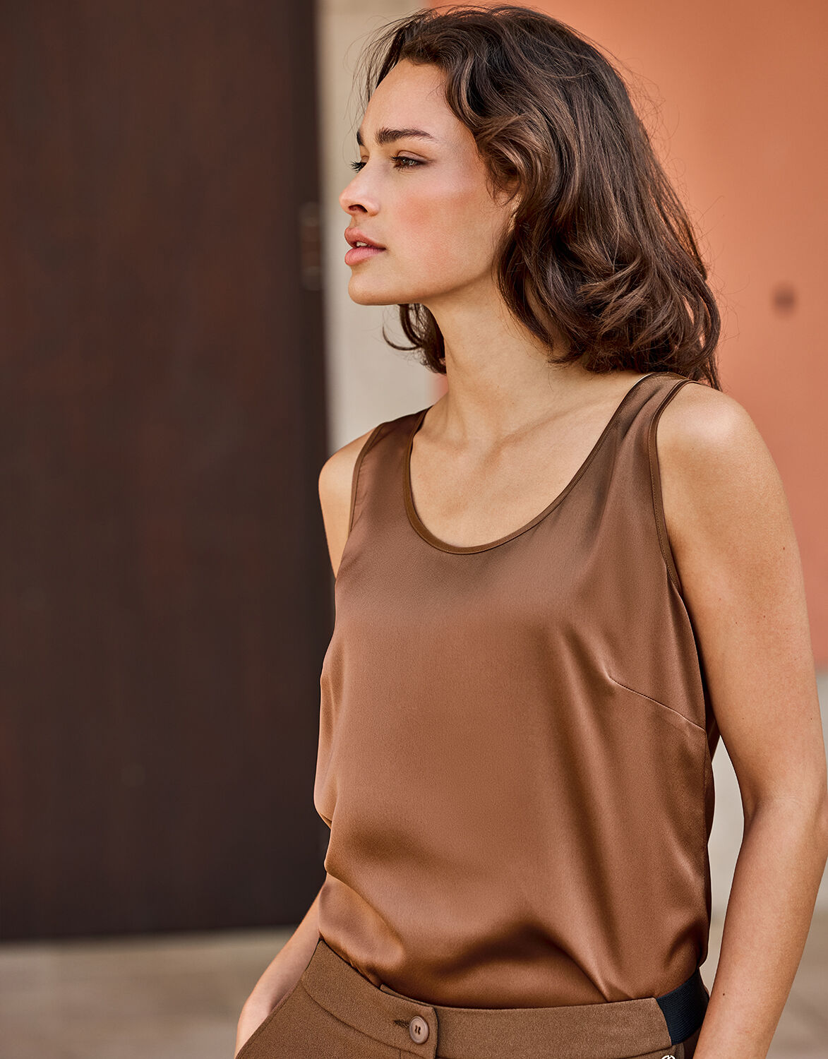 Model standing in the Zelda Cacao Brown top in satin with matching trousers.