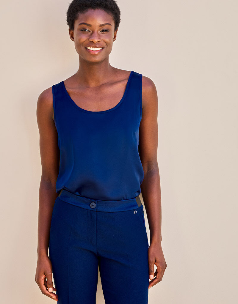 Model standing in the Zelda Sapphire Blue top in satin with matching trousers.