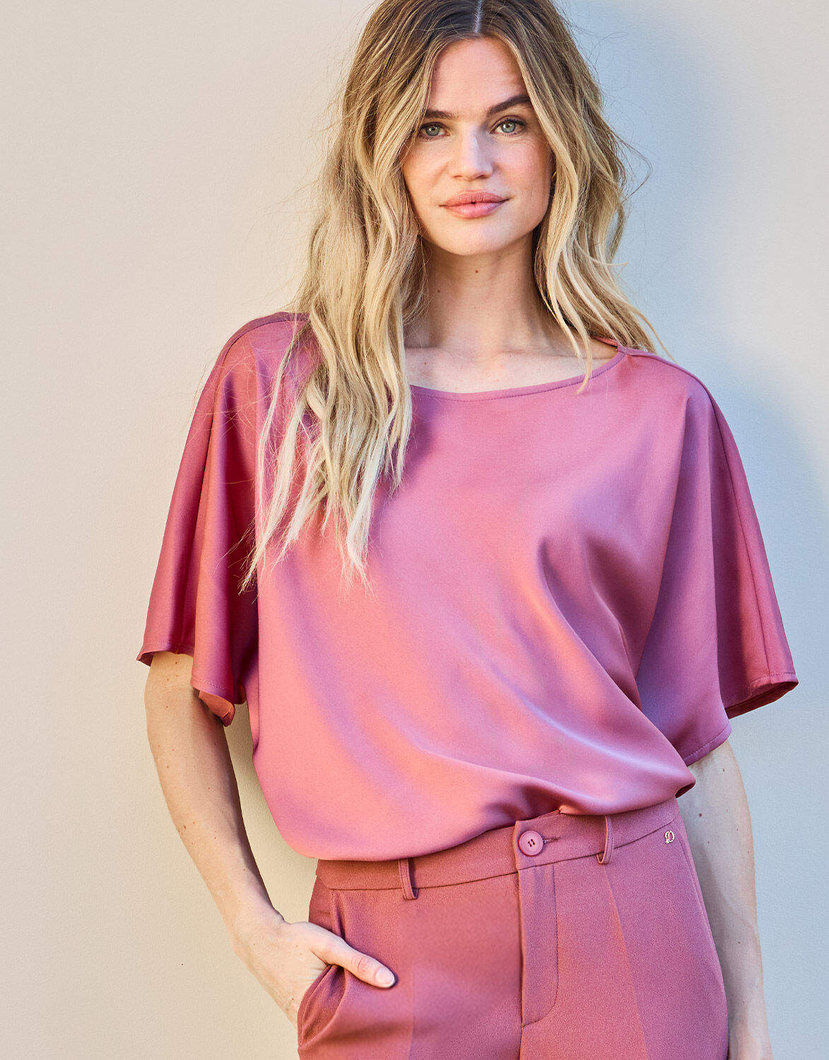 Model standing in the Jamie Dusty Pink top in satin with matching trousers.