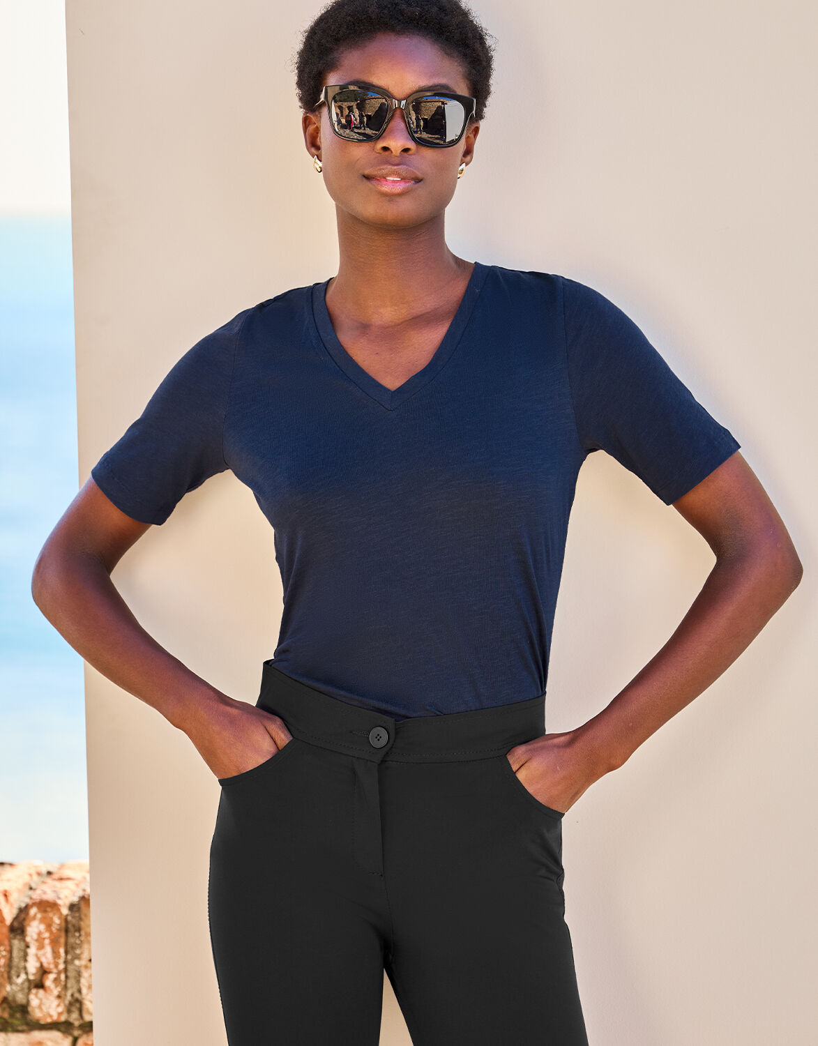 Model standing in the Chiara Midnight Blue T-shirt in cotton with black trousers.