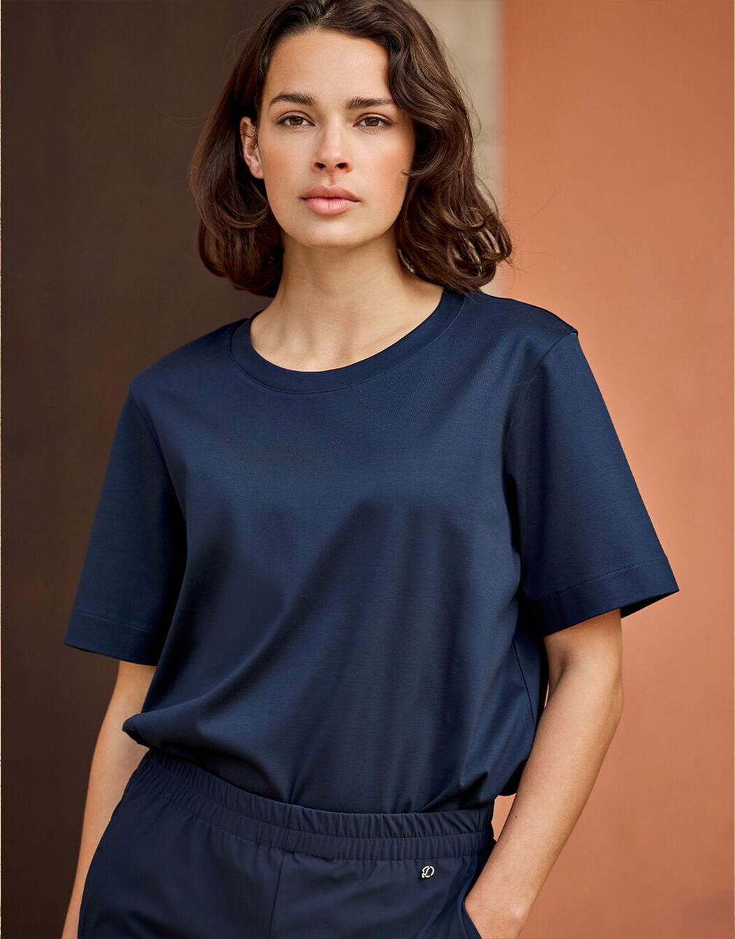 Model standing in the Faith Midnight Blue T-shirt in cotton heavy with matching joggers.