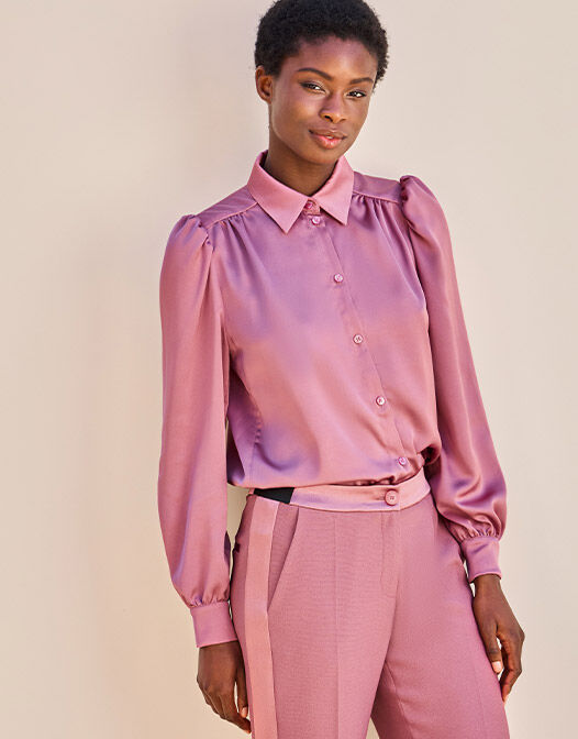 Model standing in the Tilda Dusty Pink blouse in satin with matching trousers.