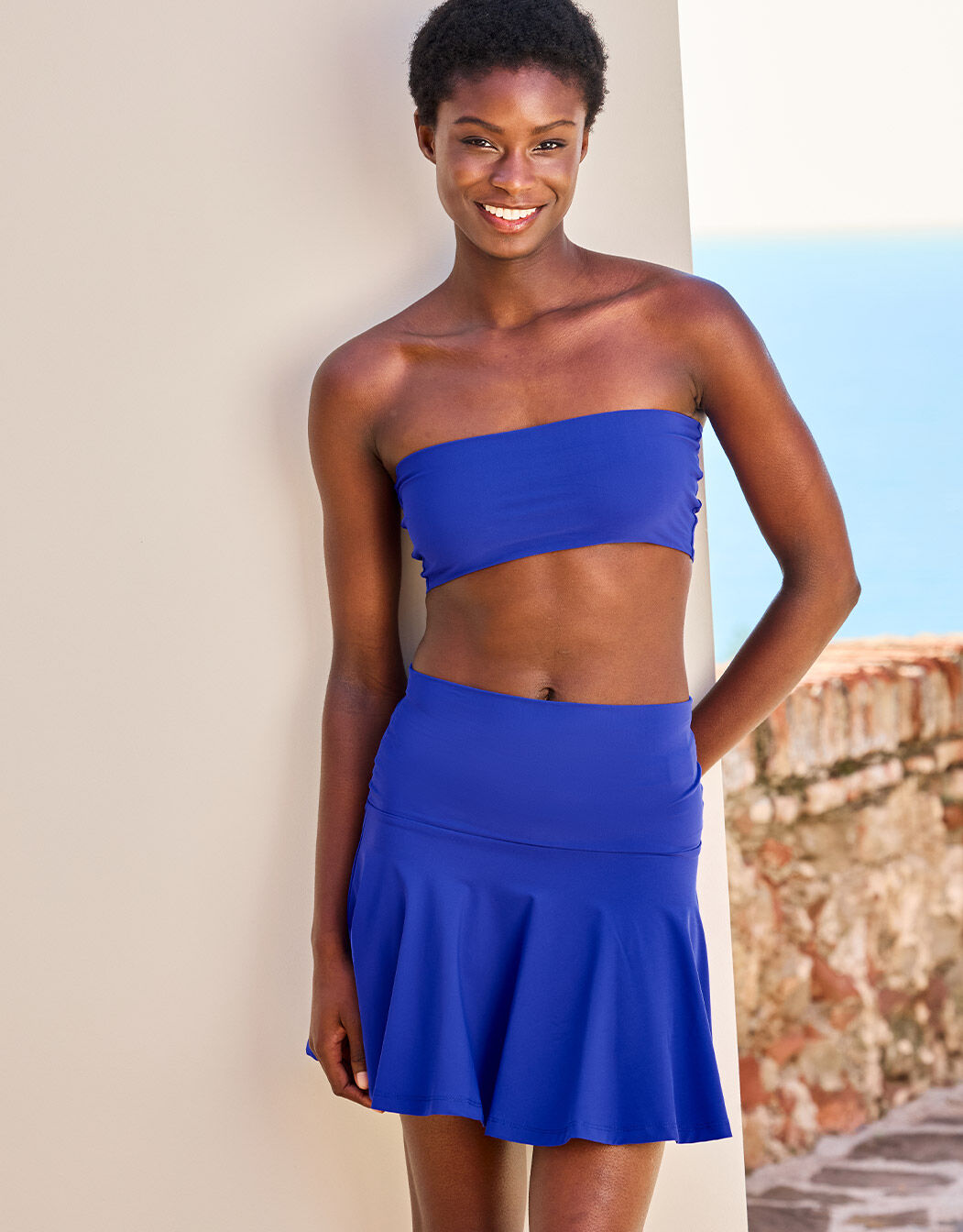 Model standing in the Rebel Marine Blue top in jersey lycra with a matching skirt.