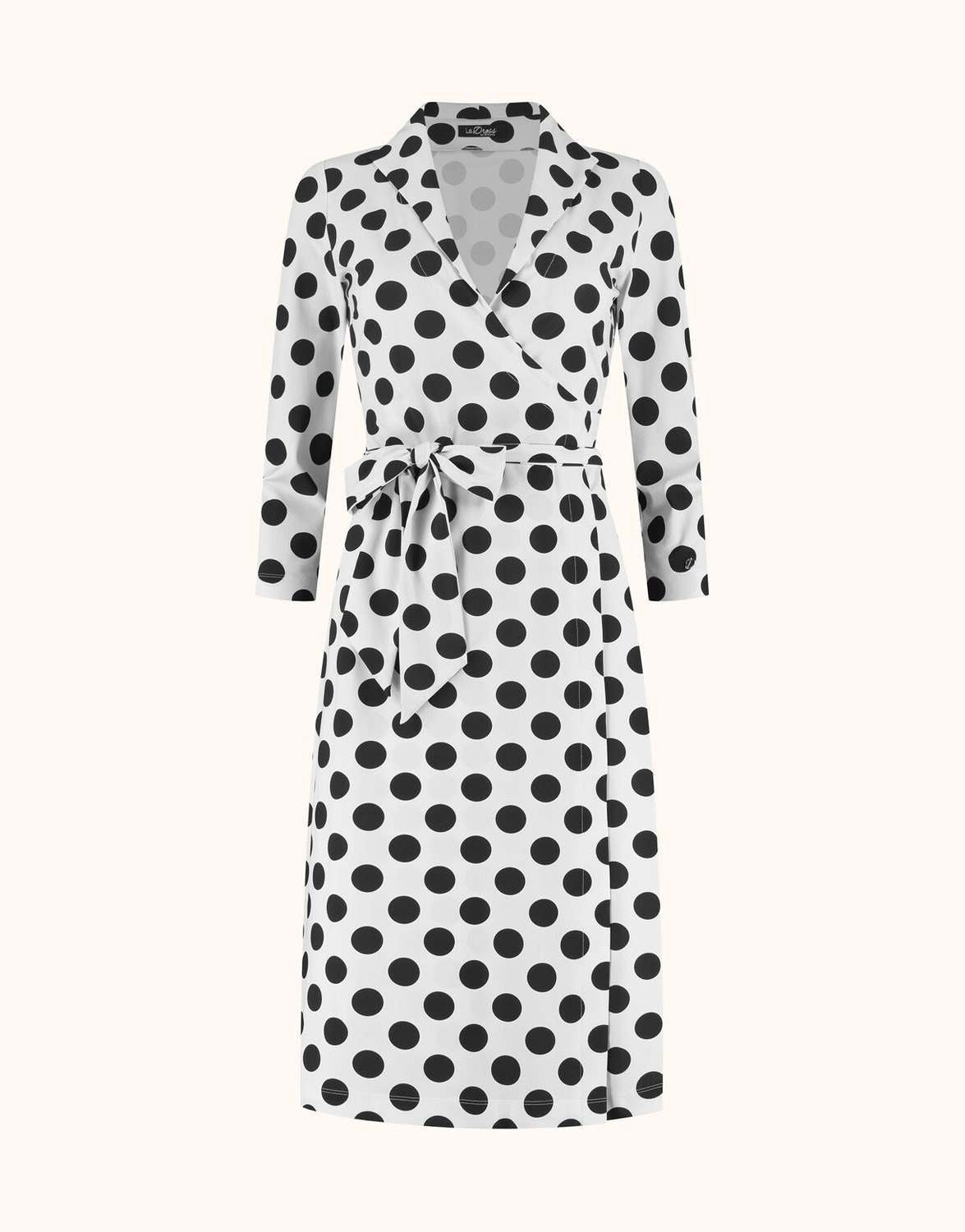 Packshot of the Penelope Black dot dress in jersey lycra with a wrap front and tie belt.