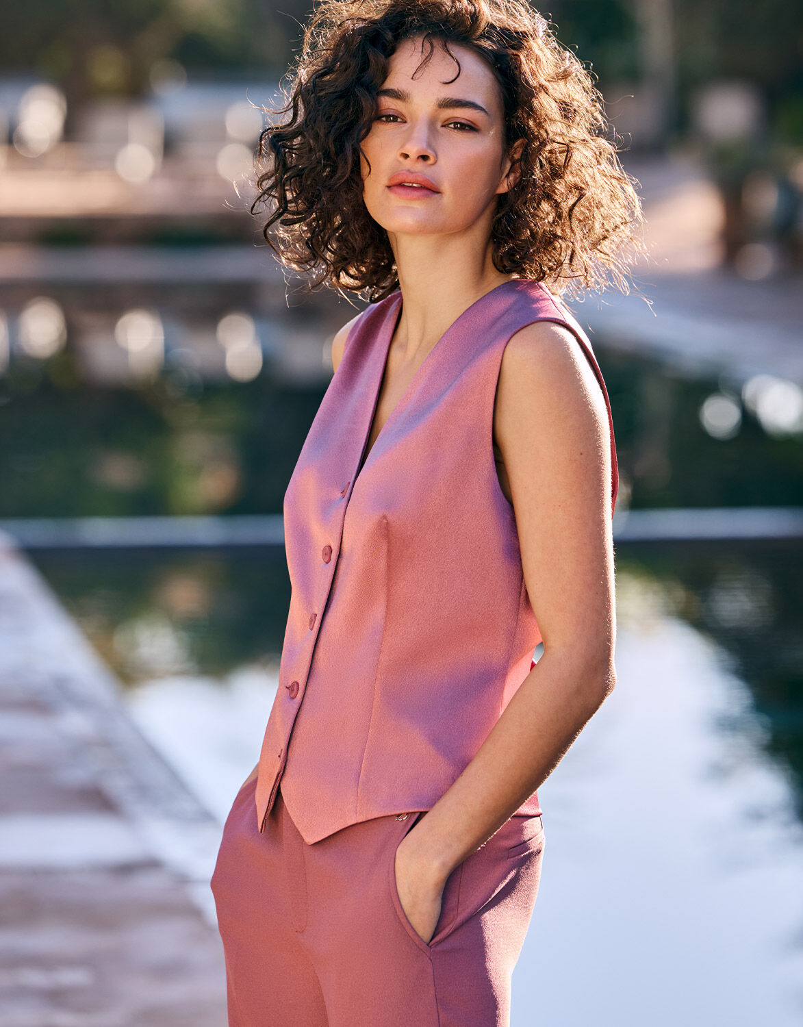 Model standing in the Charlize Dusty Pink Satin waistcoat in crepe satin with matching trousers.