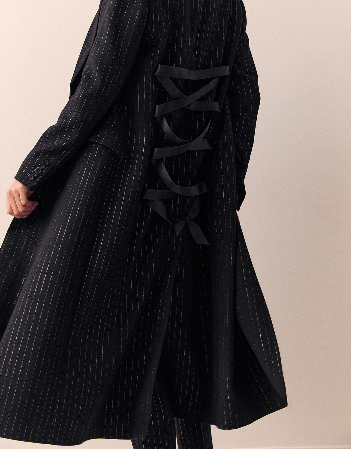Detail of the Jakarta Black coat in stretch woven, showing the laced back panel.