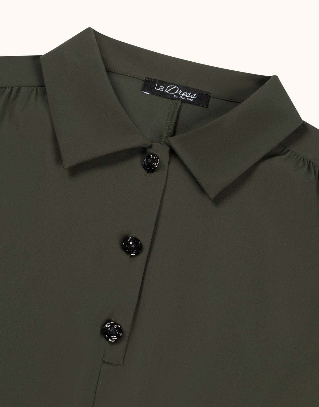 Detail of the Eleanor Deep Moss tunic in jersey lycra, showing the buttons and collar.