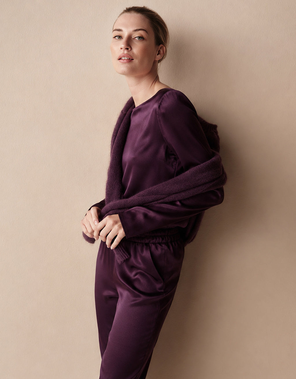 Model in the Dorian Deep Aubergine top in satin with the matching Verona Deep Aubergine Satin trousers.