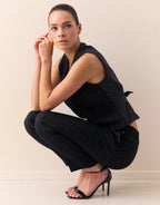 Model crouching in the Istanbul Black waistcoat in stretch woven with pinstripes.