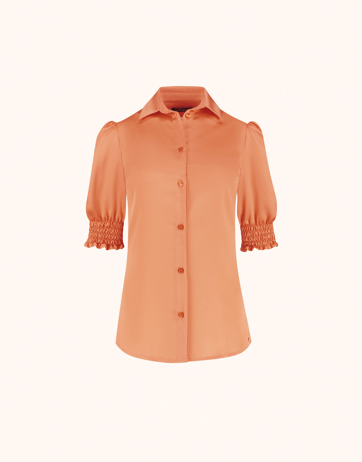 Packshot of the Miuccia Soft Apricot blouse in satin with a collar and smocked cuffs.
