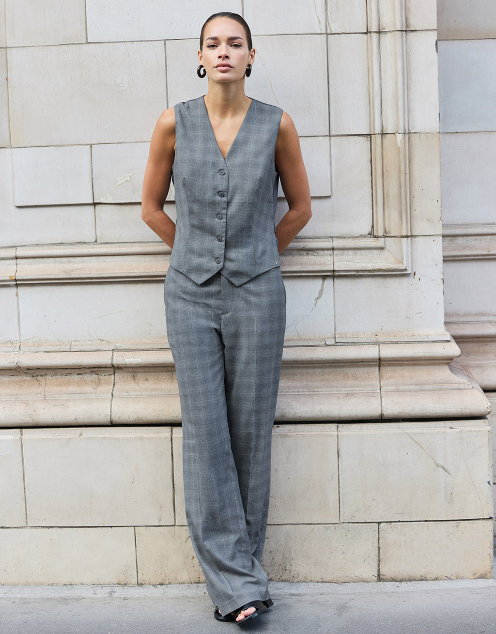 Model standing in the Naples Light Grey Check trousers in stretch woven with the Jules waistcoat.