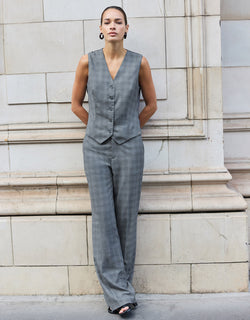 Model standing in the Naples Light Grey Check trousers in stretch woven with the Jules waistcoat.