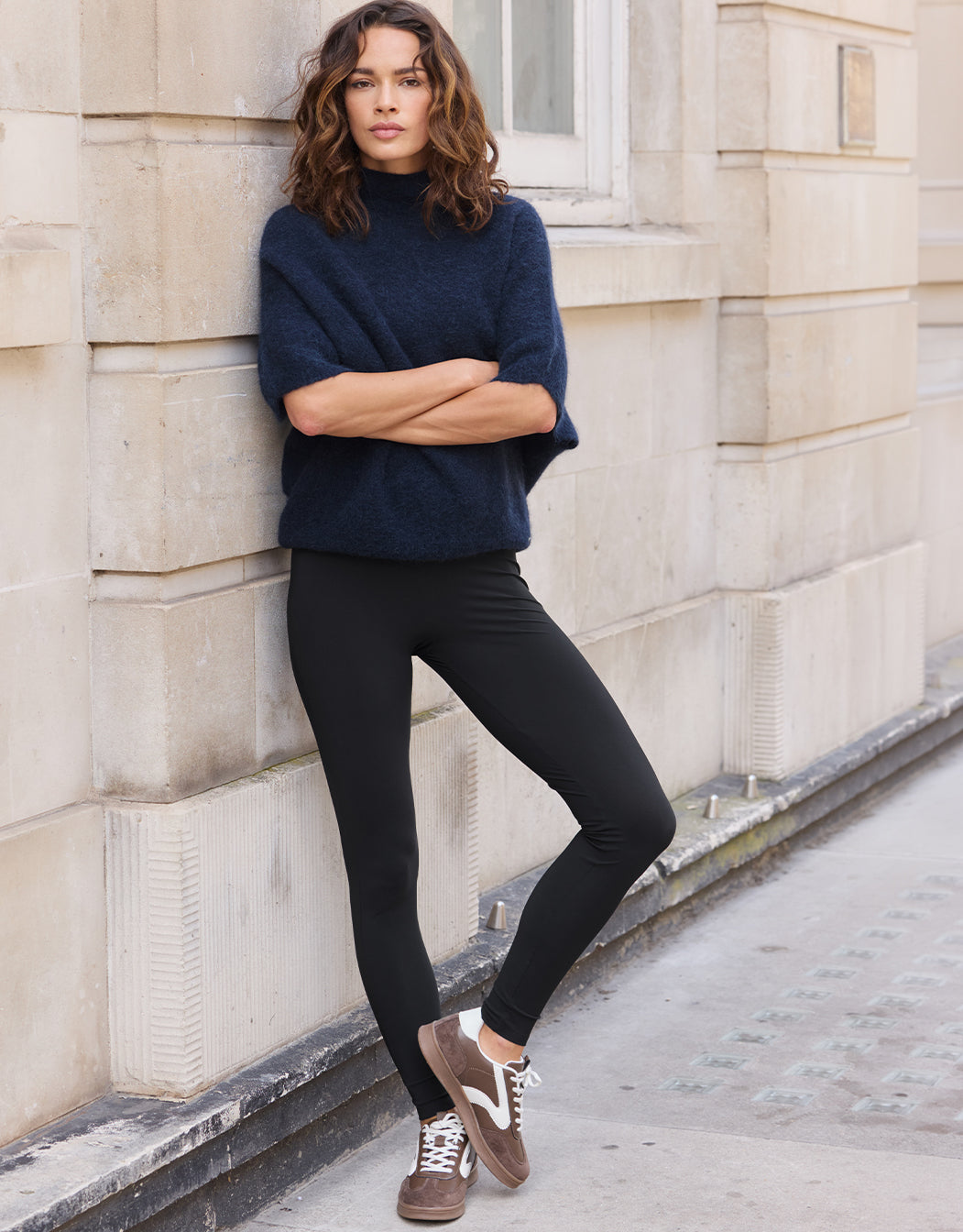 Model leaning in the Rio Black leggings in jersey lycra with a navy jumper.