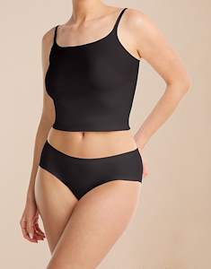 Model standing in the Noa 2-pack Black/Black shaping brief in jersey lycra with a black top.