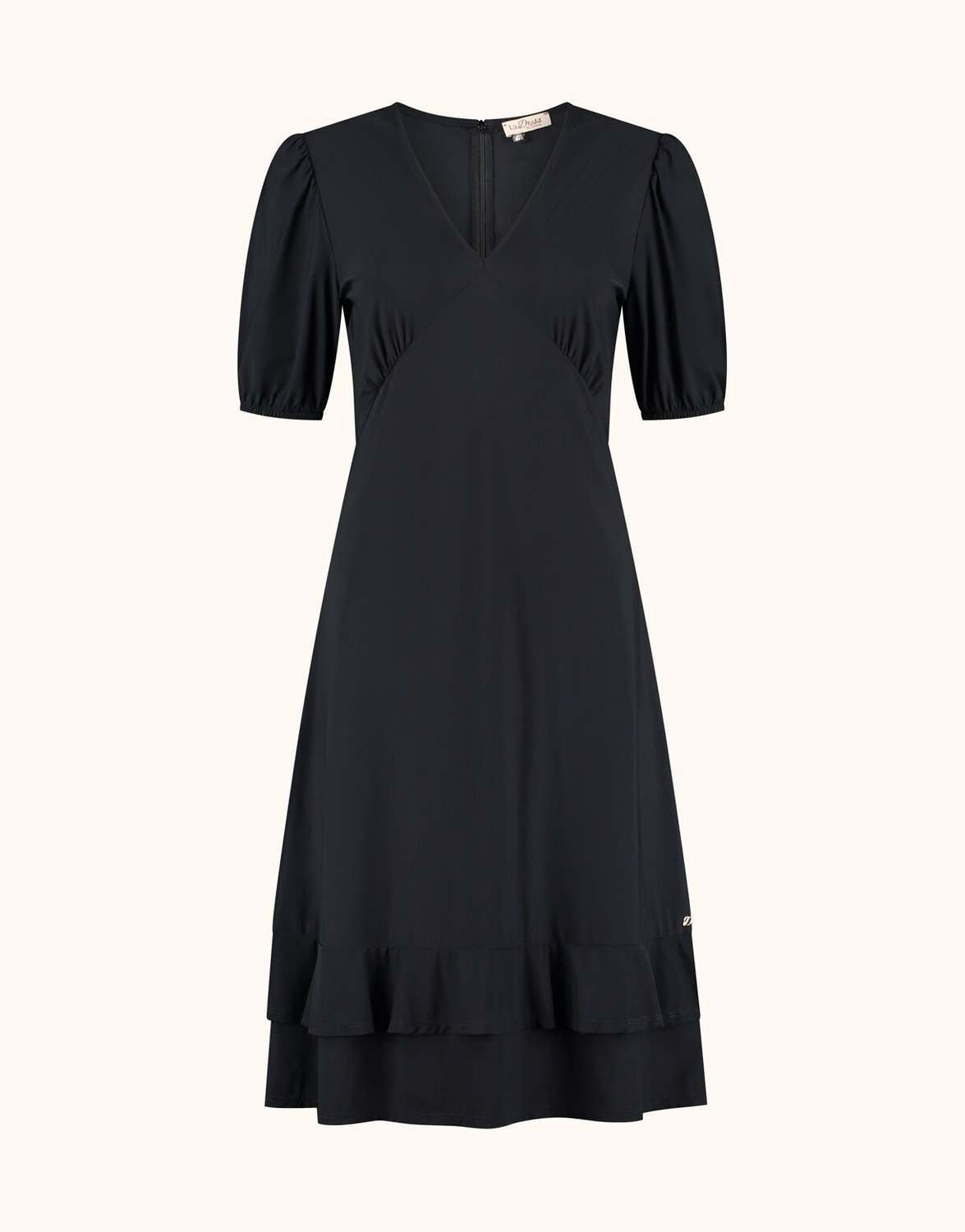 Packshot of the Kaya Black dress in jersey lycra with a V-neck and a ruffled hem.