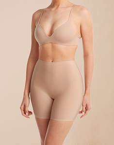 Model standing in the Ginny 2-pack Nude/Nude shaping shorts in jersey lycra with a nude bra.