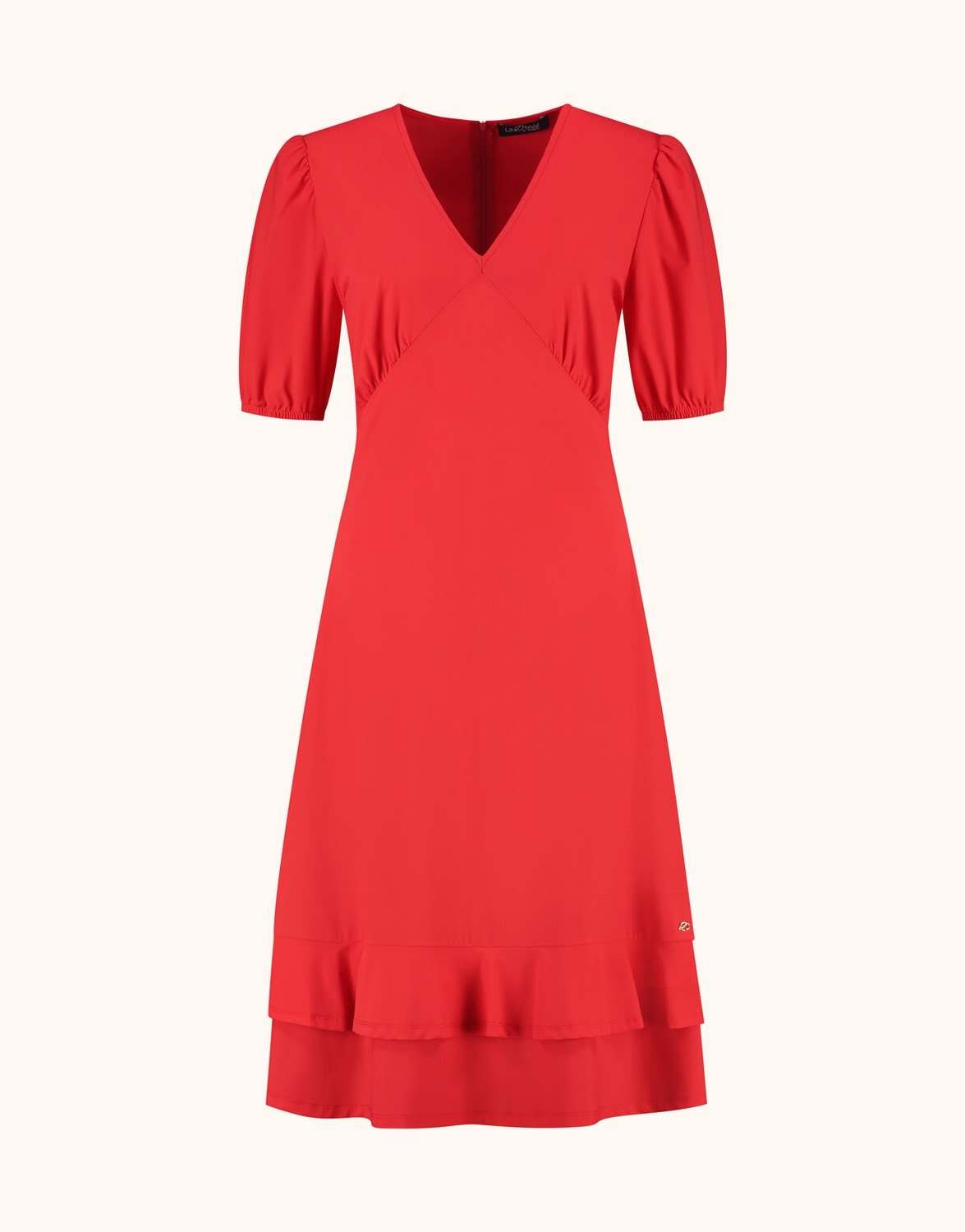 Packshot of the Kaya Hibiscus dress in jersey lycra with a V-neck and a ruffled hem.