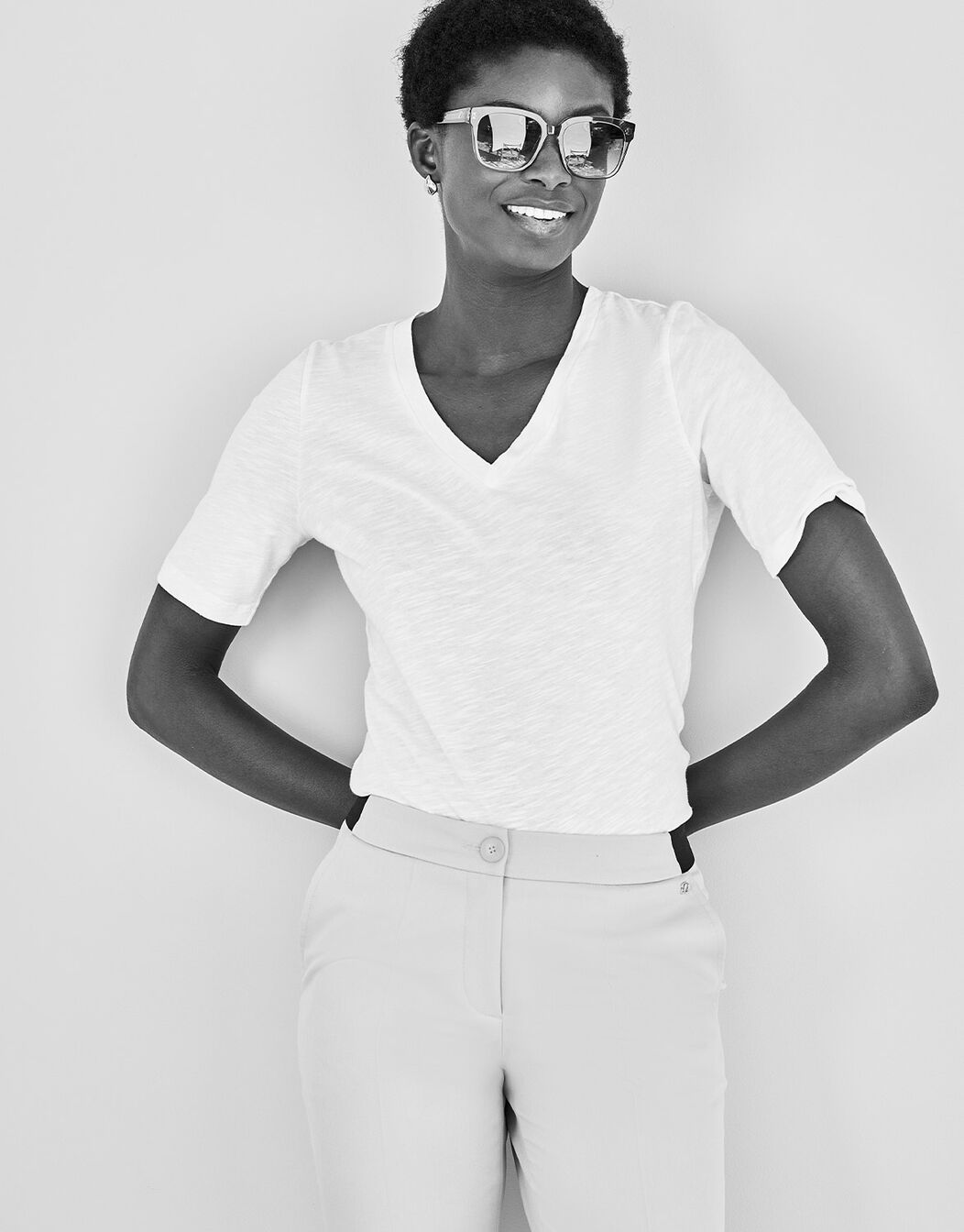 Model standing in the Chiara White T-shirt in cotton, in a black and white image.