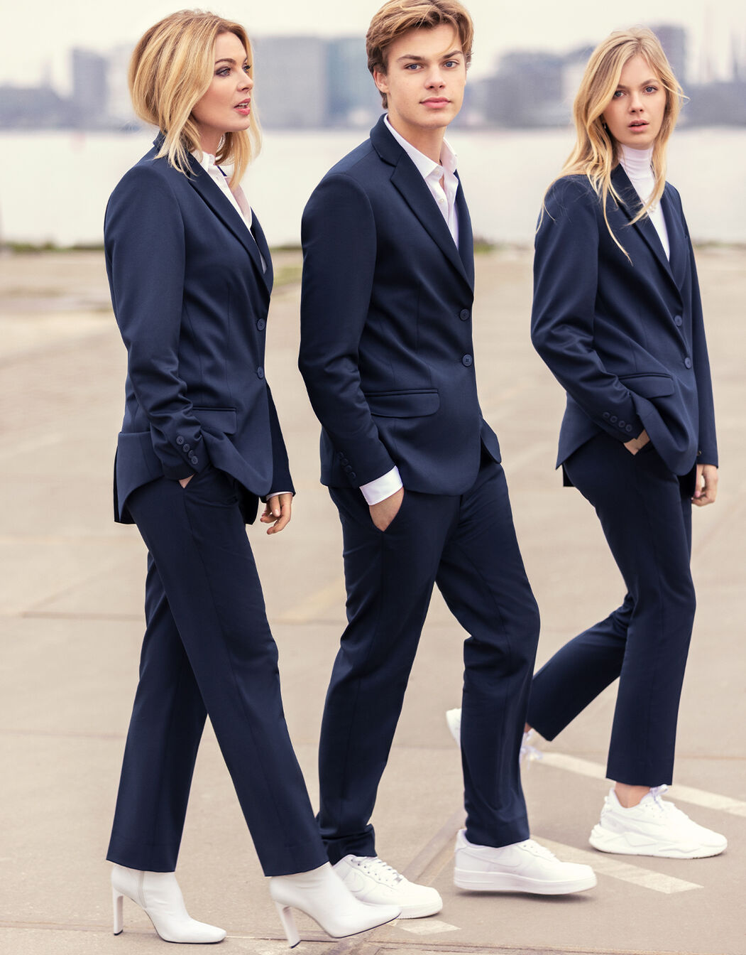 Models standing in the Lise Navy trousers in viscose blend suiting with matching blazers.
