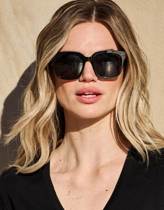 Model wearing the Ann Black sunglasses with a square acetate frame.