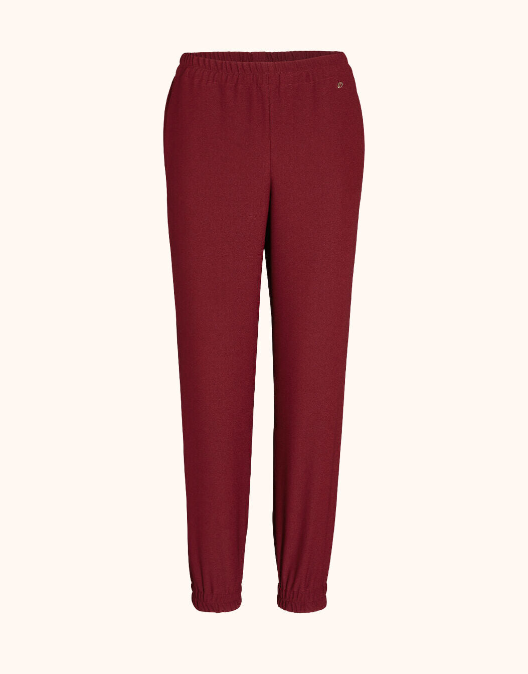 Packshot of the Verona Ruby Red trousers in crepe satin with cuffed hems.