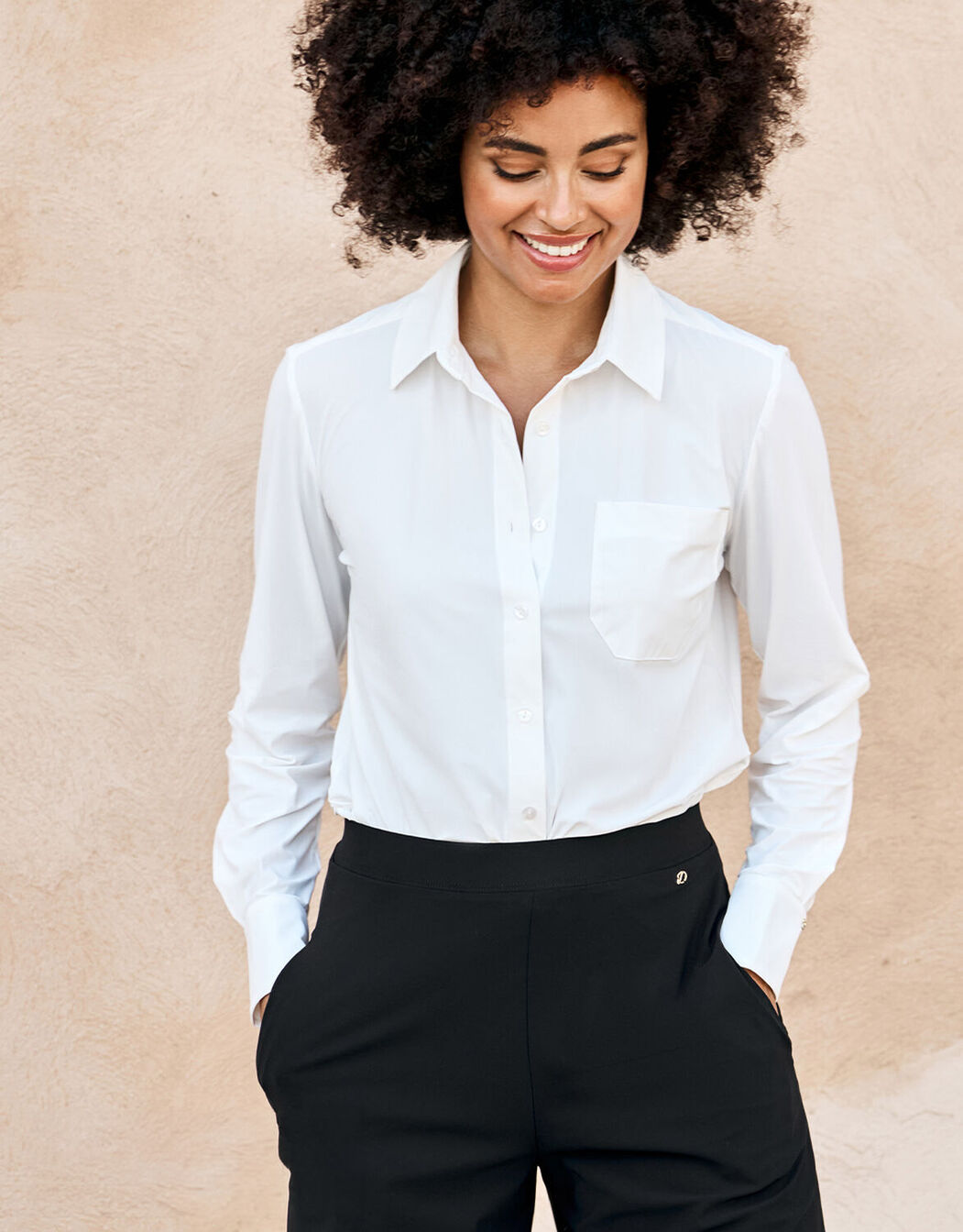 Model wearing the Annie White shirt in jersey lycra with black trousers.