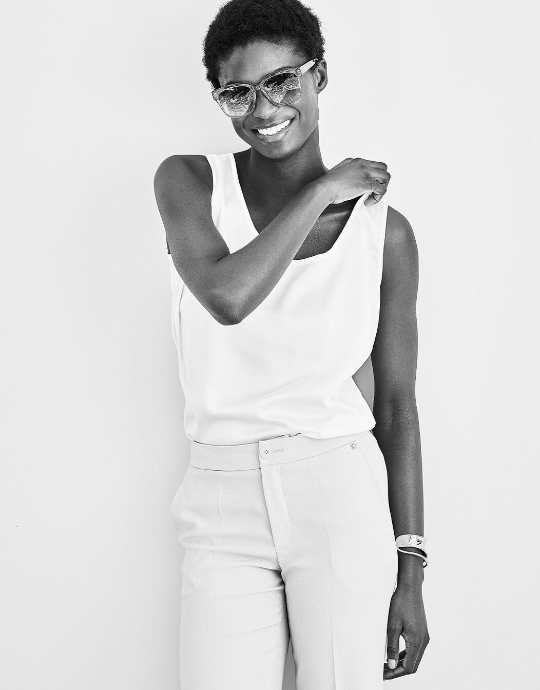 Model standing in the Zelda Ivory top in satin, in a black and white image.