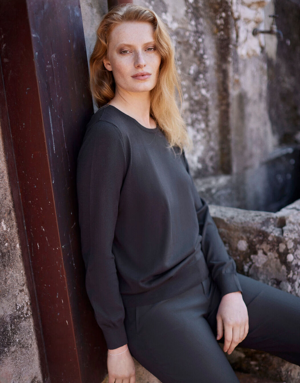 Model standing in the Mia Antra jumper in organic certified cotton with a round neck.
