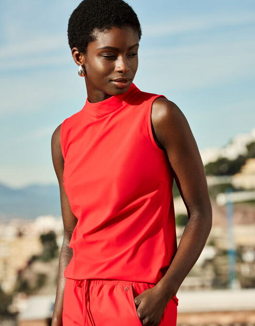 Model outdoors in the Amber Hibiscus sleeveless top with matching red shorts.