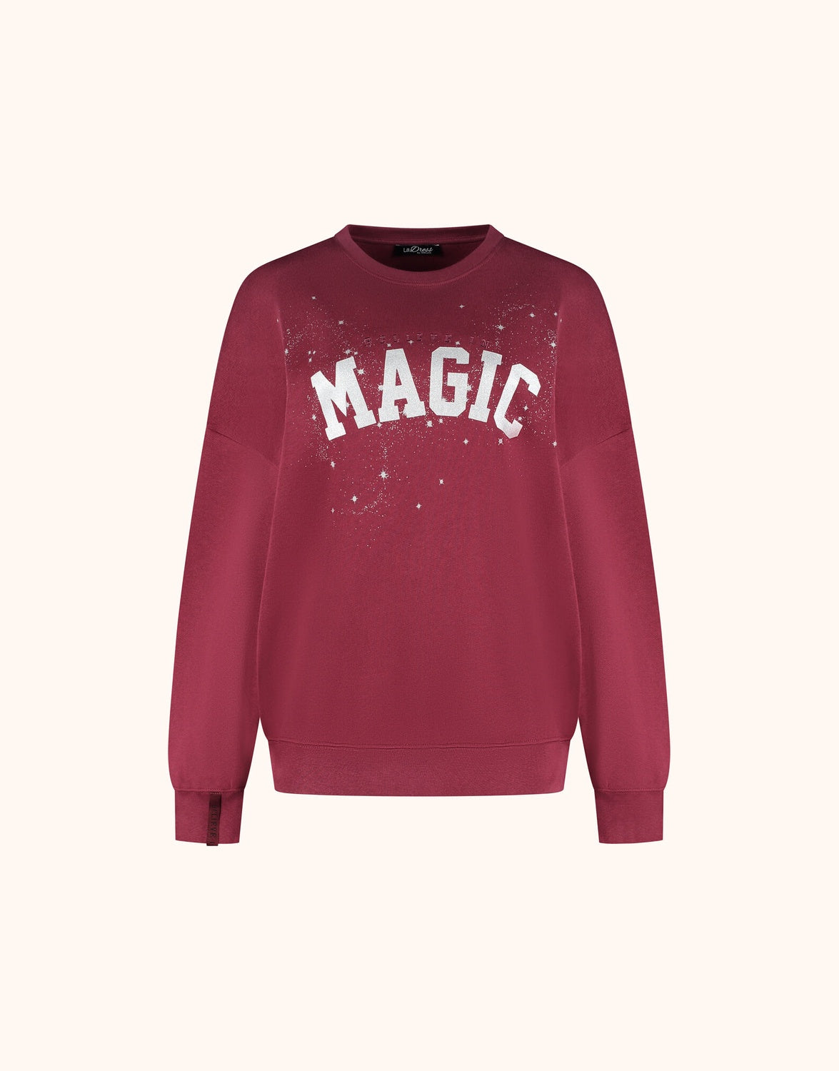 Packshot of the Story Sweater Ruby Red in organic cotton knit with a MAGIC print.