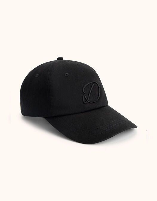 Packshot of the Skyler Black cap in cotton with an embroidered logo on the front.