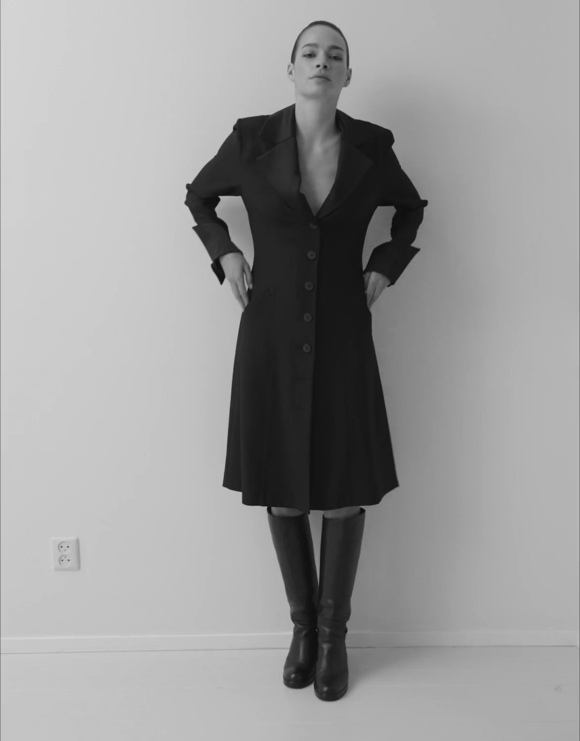Video of a model wearing a crepe satin coat dress, shown on the Milan Buttery yellow page.