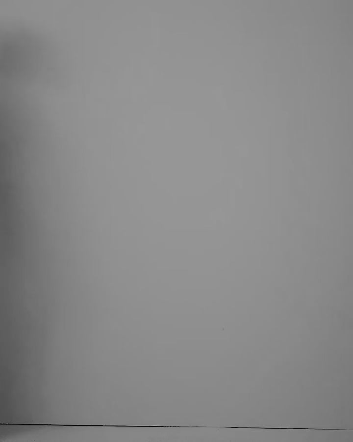 Video of a model wearing the Esmee Black blouse in jersey lycra, seen from the side.
